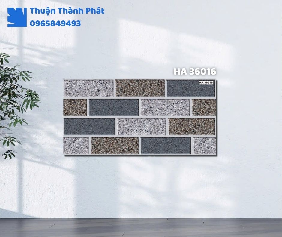 Gạch ốp tường HA 36016 Thanh Thanh ốp phòng khách, họa tiết vân đá sang trọng, tông xám đậm tinh tế.